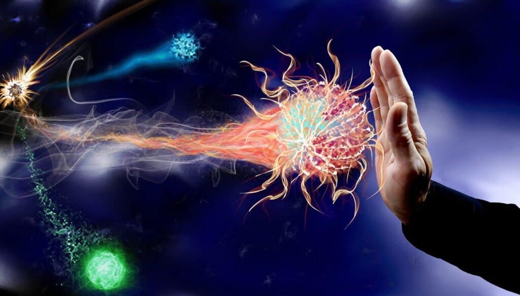 Colorful sparking balls coming from the left side of the image on collision with the palm of a hand.  This is on a dark blue background.  It shows that cravings and relapse prevention are possible even if it is an intense feeling.  