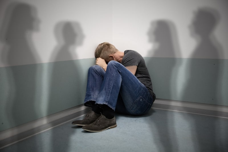 Psychosis. Persecutory delusions (also called paranoia) are the most common type in psychosis. The picture shows a man hiding in the corner of a room with human shadows on the wall