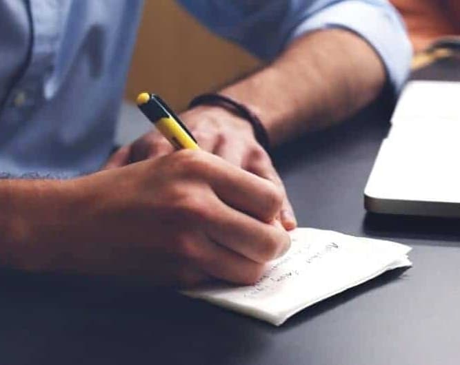 EMDR. History taking and treatment planning. Picture shows the arms of s sitting psychologists, taking notes in his notebook