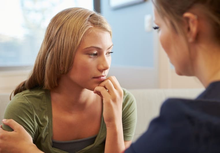 Approaches to Counselling and Psychotherapy. The image shows two 2 women sitting across from each other in the counselling session. 